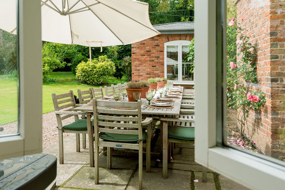 Stylish outdoor dining on the south facing terrace which is a suntrap
