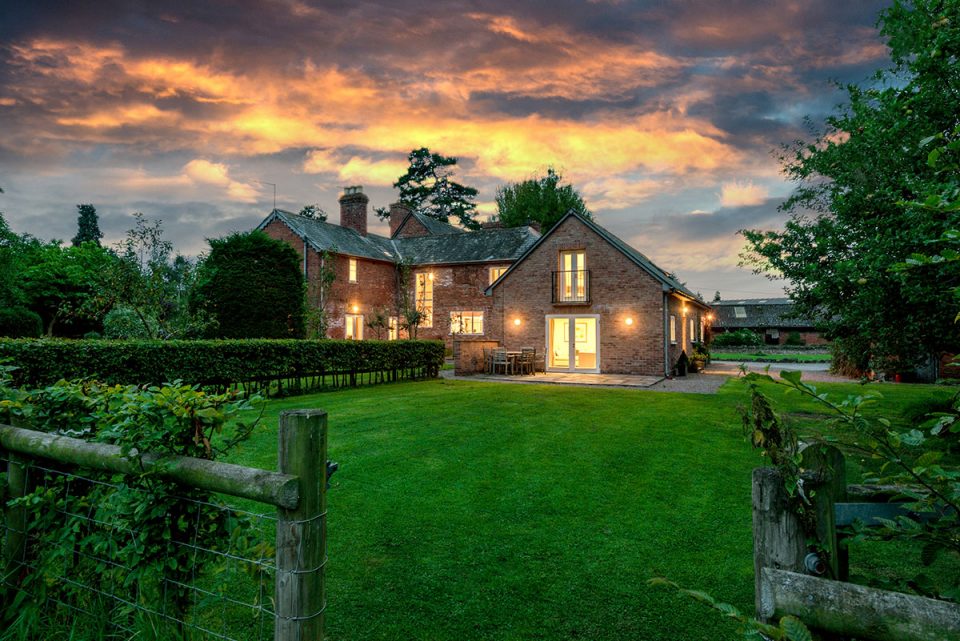 View of cottage on the right handside and Monnington House on the left at dusk