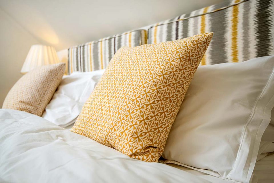 Gorgeous sumptuous luxury egyptien linen on super king bed in Geiger bedroom. Garden cottage sleeps 6 guests in 3 en-suite bedrooms and has a private garden | Monnington House and Cottages, Herefordshire