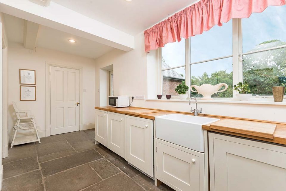 The laundry room with traditional larder cupboard and overflow fridge/freezer