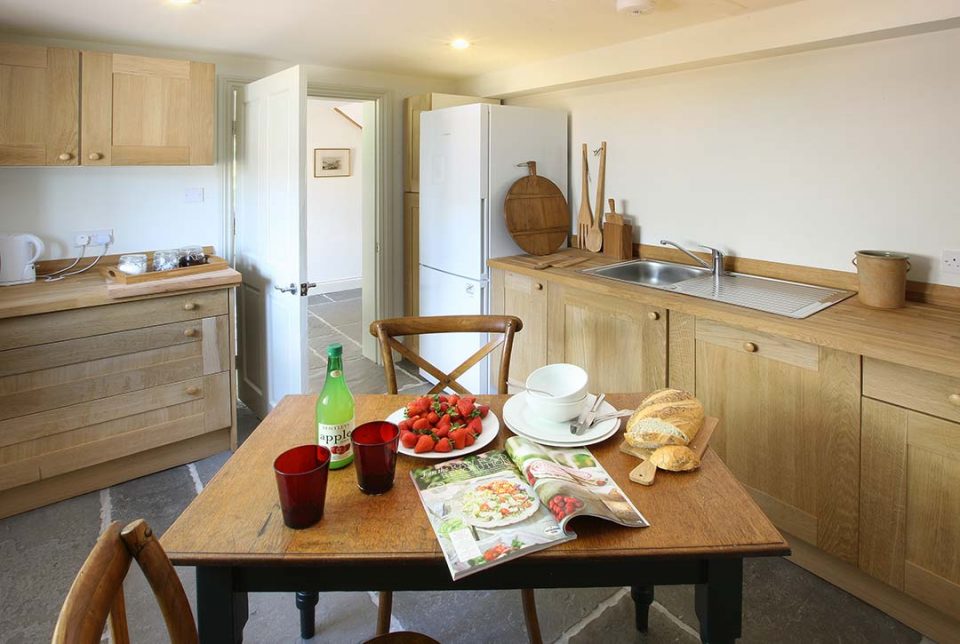 The kitchen in the cottage which is basically equipped and has a handy overflow fridge freezer