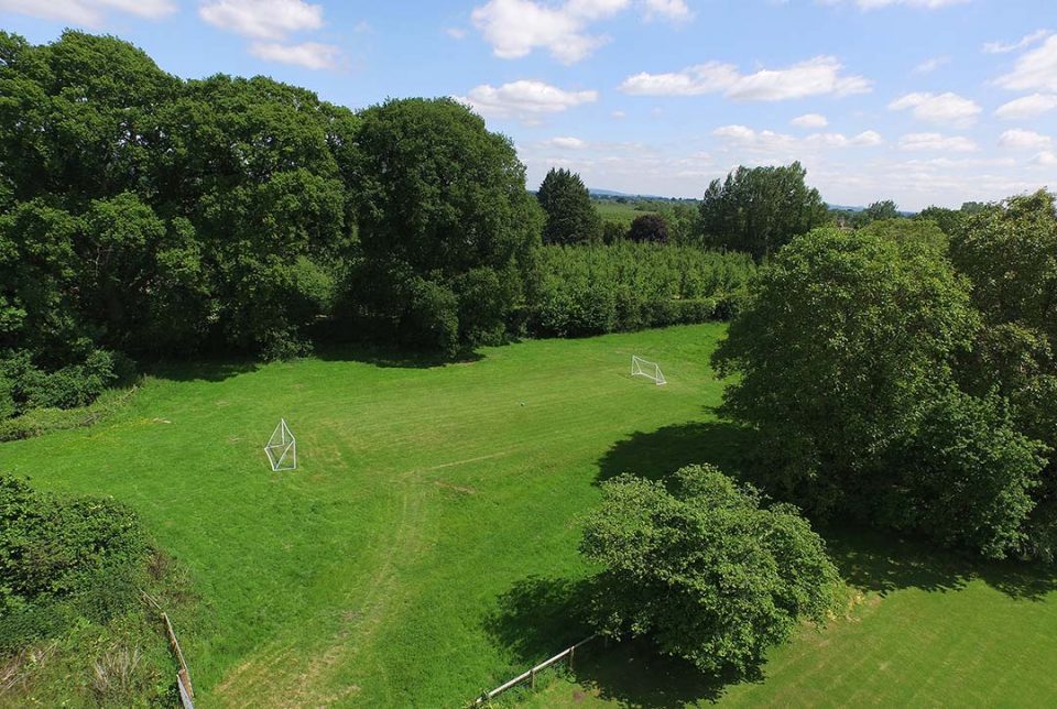 The huge playing field with football goals